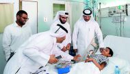 Ooredoo volunteers meet a patient at Hamad General Hospital’s Children Ward.
