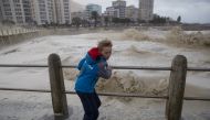CAPE TOWN, SOUTH AFRICA: A kid stands over the bridge as the huge waves hit coastline during the heavy storm in Cape Town, South Africa on June 7, 2017. (Ashraf Hendricks - Anadolu Agency)
