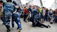 Russian police officers take into custody a protester during an unauthorized rally after Russian liberal opposition leader Alexei Navalny called to hold a protest in Tverskaya street in Moscow, Russia on June 12, 2017.   Sefa Karacan - AA
