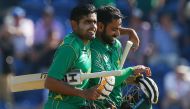 Pakistan's Mohammad Hafeez (R) and Pakistan's Babar Azam walks back to the pavilion after Pakistan won the ICC Champions Trophy semi-final cricket match between England and Pakistan in Cardiff on June 14, 2017. Set just 212 for victory, Pakistan finished 