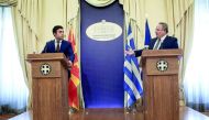 Macedonian Foreign Minister Nikola Dimitrov (left) with his Greek counterpart Nikos Kotzias after their meeting in Athens, yesterday.