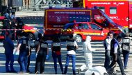 Criminal police inspect the body of a suspect at the scene of an incident in which a car rammed a gendarmerie van on the Champs-Elysees Avenue in Paris, France, June 19, 2017. Reuters/Gonzalo Fuentes
