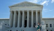 A news assistant runs out after the US Supreme Court granted parts of the Trump administration's emergency request to put his travel ban into effect immediately while the legal battle continues, in Washington, U.S., June 26, 2017. (REUTERS/Yuri Gripas)
