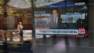 A large television in a bank shows CNN's audio only broadcast of White House Press Secretary Sean Spicer's briefing in Boston, Massachusetts, U.S. June 26, 2017. REUTERS/Brian Snyder