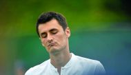 Australia's Bernard Tomic reacts against Germany's Mischa Zverev during their men's singles first round match at Wimbledon.