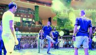 Barcelona's Gerard  Pique (centre) shows off his skills during an interaction with fans while his team-mates Sergio Busquets and Jordi Alba look on at Mall of Qatar yesterday. Picture: Baher Amin / The Peninsula