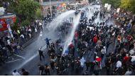 German riot police use water cannons against protesters during the demonstrations during the G20 summit in Hamburg, Germany, July 6, 2017. Credit: Fabrizio Bensch/Reuters.