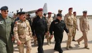A handout picture released by the Iraqi prime minister's press office on July 9, 2017, shows Iraqi Prime Minister Haider al-Abadi (3rd from R) walking alongside police and army officers upon his arrival in Mosul. ( AFP / IRAQI PRIME MINISTER'S PRESS OFFIC