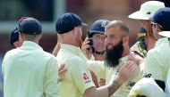 England's Moeen Ali (right) celebrates the wicket of South Africa's JP Duminy with team-mates during the fourth day of the first Test match at Lord's Cricket Ground in central London, yesterday.