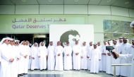 Officials of Ashghal with the mural of Emir H H Sheikh Tamim bin Hamad Al Thani in front of its office in Doha.