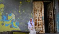A Palestinian elderly woman sits outside her house at al-Shatee refugee camp during a heatwave in Gaza City on July 12, 2017. AFP / Mohammed Abed