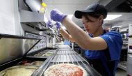 A staff member prepares a pizza at a Domino's Pizza restaurant in Moscow, Russia, July 14, 2017. Picture taken July 14, 2017. REUTERS/Sergei Karpukhin