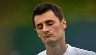 Australia's Bernard Tomic reacting against Germany's Mischa Zverev during their men's singles first round match on the second day at 2017 Wimbledon Championships in London. (AFP / JUSTIN TALLIS)