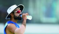 Indian cricket team captain Virat Kohli drinks water during a practice session at Galle International Cricket Stadium in Galle yesterday. India will play three Tests, five one-day internationals and a Twenty20 game in Sri Lanka. The first Test starts on J