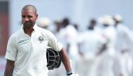 Indian batsman Shikhar Dhawan leaves the pitch after being dismissed during the first day of the first Test match between Sri Lanka and India at Galle International Cricket Stadium in Galle on July 26, 2017. (AFP / ISHARA S. KODIKARA)