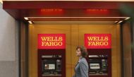 A woman walks past teller machines at a Wells Fargo bank in San Francisco in this October 10, 2013 file photo (REUTERS / Robert Galbraith) 