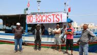 Tunisian fishermen gather on August 6, 2017 in the port of Zarzis in southeastern Tunisia to protest against a possible berthing of the C-Star vessel, hired by far-right activists from a group which calls itself 