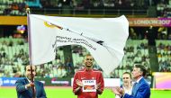 Qatar Athletics Federation and Vice-President of the Doha 2019 Organising Committee, Dr Thani Abdulrahman Al Kuwari waves the IAAF flag during the official flag handing over ceremony at the end of the IAAF World Championships in London on Sunday, watched 