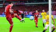 Shanghai SIPG’s Wang Shenchao (left) scores against Guangzhou Evergrande during the AFC Champions League quater-final in Shanghai, yesterday.