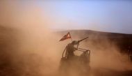 A picture taken on an army-organized press tour shows Lebanese army soldiers with the 6th Brigade driving a buggy bearing the Lebanese flag in an area they recently took from the Islamic State (IS) group in Jurud Ras Baalbek on the Syrian-Lebanese border 