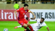 Iran’s Ashkan Dejgah (right) tackles South Korea’s Ki Sung-yueng during the 2018 World Cup qualifying football match at the Azadi Stadium in Tehran in the 2016 file picture.