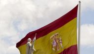 A statue of Christopher Columbus with an extended hand is seen in front of a Spanish flag in central Madrid, June 11, 2012 (Reuters / Paul Hanna) 
