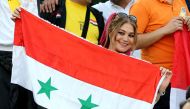 A supporter of Syria's national team attends the FIFA World Cup 2018 qualification football match between Syria and Iran at the Azadi Stadium in Tehran on September 5, 2017.  AFP / Atta Kenare