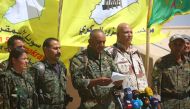 Ahmad Abu Khawlah (3rd-R), chief of the Deir Ezzor Military Council (DEMC) -- a coalition of Arab tribes and fighters that belongs to the broader US-backed Syrian Democratic Forces -- speaks during a press conference in the northeastern Syrian village of 