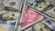 Benjamin Franklin US 100 dollar banknotes and a Chinese 100 yuan banknote with the late Chinese Chairman Mao Zedong are seen in this January 21, 2016 picture illustration (REUTERS / Jason Lee) 