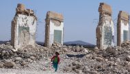 A girl runs near a damaged site in the Quneitra countryside, Syria September 12, 2017. REUTERS/Alaa Al-Faqir