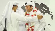 Qatar Motor and Motorcycle Federation (QMMF) President Abdulrahman Al Mannai (left) greets Qatar’s star rally driver Nasser Saleh Al Attiyah during a felicitation ceremony held on Thursday. (Photo: Salim Matramkot)