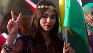A Syrian Kurd gestures, in the northeastern Syrian city of Qamishli on September 26, 2017, during a gathering in support of the independence referendum in Iraq's autonomous northern Kurdish region. / AFP / Delil souleiman
