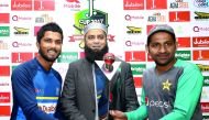 Rival captains Sarfraz Ahmed (right) of Pakistan and Dinesh Chandimal (left) of Sri lanka pose with the trophy ahead of Test series in Abu Dhabi yesterday.