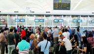 People stand in line in front of check-in desk to leave northern Iraq at Erbil International Airport in Erbil, Iraq, yesterday.