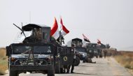 Vehicles of the Iraqi forces and Hashed al-Shaabi (Popular Mobilisation) paramilitaries are seen on the advance towards the Islamic State (IS) group's stronghold of Hawija on October 3, 2017, to recapture the town from the jihadists. Iraqi forces on Septe