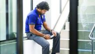 Sri Lanka’s Lasith Malinga looks at his mobile phone while waiting at Sri Lanka Cricket headquarters in Colombo in this file photo.