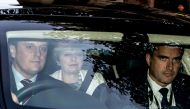 Britain's Prime Minister Theresa May (C) arrives in a car at the studios of the national talk and phone-in radio station, LBC radio, in central London on October 10, 2017.  AFP / Daniel Leal-Olivas