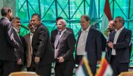 Khaled Fawzi (C) head of the Egyptian Intelligence services laugh with Hamas leader Izzat al-Rishq (2nd-R) and Hamas' leader in the Gaza Strip Yahya Sinwar (background) in the presence of Fatah's Azzam al-Ahmad (C) and Rawhi Fattouh (3rd-R) following the 