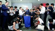 Kobe Steel President and CEO Hiroya Kawasaki (centre) speaks to the media after meeting with Ministry of Economy, Trade and Industry’s Director-General of Manufacturing Industries Bureau, Akihiro Tada at the M ninistry in Tokyo, Japan, yesterday.