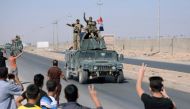 People gather on the road as they welcome Iraqi security forces members, who continue to advance in military vehicles in Kirkuk, Iraq October 16, 2017. REUTERS/Stringer