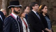 Catalan regional government president Carles Puigdemont (C), Catalan parliament president Carme Forcadell (L) and Barcelona mayor Ada Colau (R) pay their respects during a ceremony commemorating the 77th anniversary of the death of Catalan leader Lluis Co