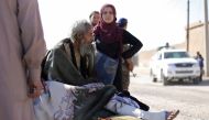 A wounded man lies on a stretcher as he flees Raqqa, Syria October 16, 2017. Reuters/ Rodi Said