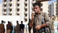 A member of the Iraqi Kurdish forces stands guard at an unfinished housing project where displaced people fleeing violence in the northern Kirkuk province are taking shelter on October 19, 2017 in Arbil, the capital of the autonomous Kurdish region of nor