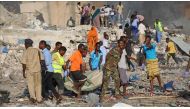 People carry bomb attack victims from the scene in the capital Mogadishu, Somalia on October 14, 2017. Sadak Mohamed - AA
