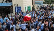 Egyptians carry the coffin of Police Cpt. Ahmed Fayez during his funeral outside a mosque in the capital Cairo's western suburb of Sixth of October, on October 21, 2017.  AFP / Fayed EL-GEZIRY
