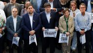 Catalan President Carles Puigdemont (C) and other Catalan regional government members attend a demonstration organised by Catalan pro-independence movements ANC (Catalan National Assembly) and Omnium Cutural, following the imprisonment of their two leader