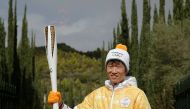 Former South Korea footballer Park Ji-sung poses with the Olympic torch with the flame during the Olympic flame lighting ceremony for the Pyeongchang 2018 Winter Olympics. REUTERS/Alkis Konstantinidis
