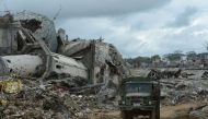 Military truck drives past the rubble of a bombed-out mosque in what was the main battle area in Marawi on the southern island of Mindanao on October 25, 2017, days after the military declared the fighting against IS-inspired Muslim militants over.  AFP /