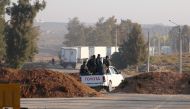 Free Syrian Army fighters ride on the back of a pickup truck near the Syrian-Jordanian border crossing in Deraa, Syria, October 23, 2017. REUTERS/Alaa Al-Faqir