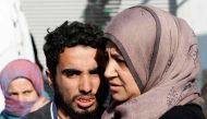A Syrian man from the recently retaken desert town of Al-Qaryatain is greeted by relatives on October 29, 2017, after the Syrian army reportedly freed him from Islamic State (IS) group detention.  AFP / LOUAI BESHARA